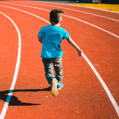 Kid running on track field