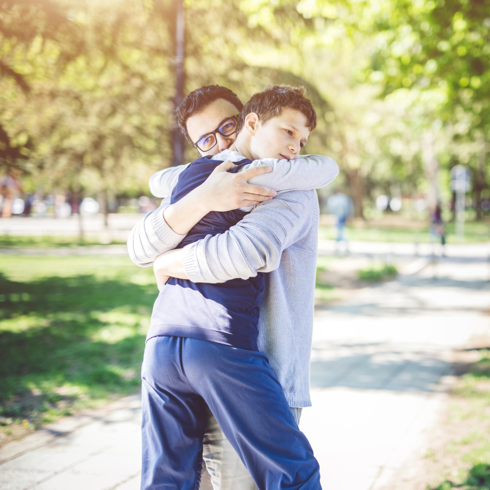 Autistic son and father hugging