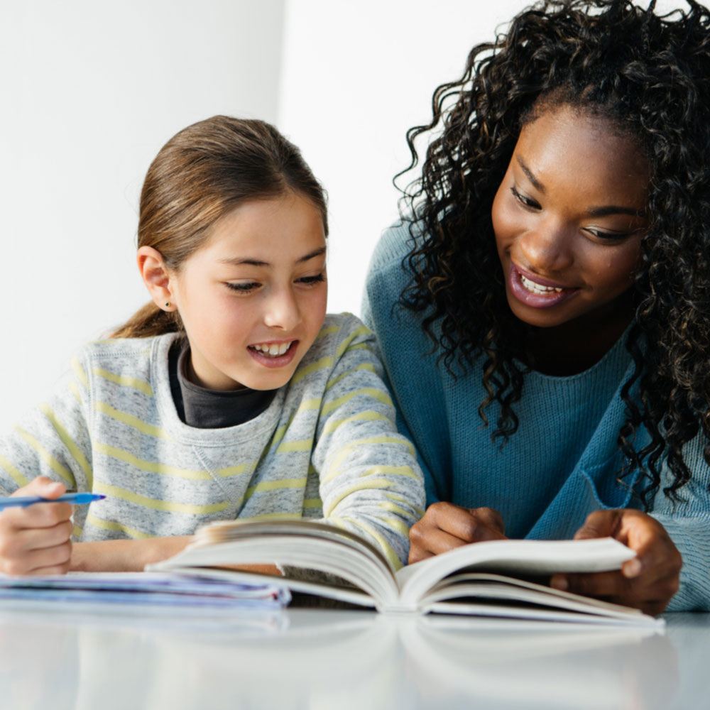 Student and tutor reading a book