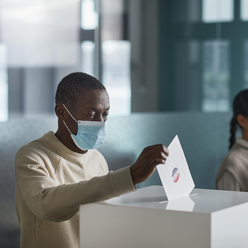 Man submitting voting ballot